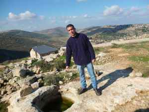 Dr. Shivi Drori next to a wine press near his winery and home